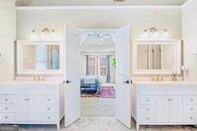 380 Victorian Ln, Duluth, GA 30097 - bathroom featuring two vanities, ornamental molding, ceiling fan, and mail area