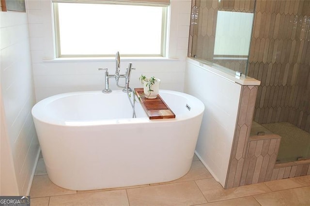 688 Harmony Rd, Temple, GA 30179 - bathroom with tile patterned flooring, a soaking tub, a tile shower, and healthy amount of natural light