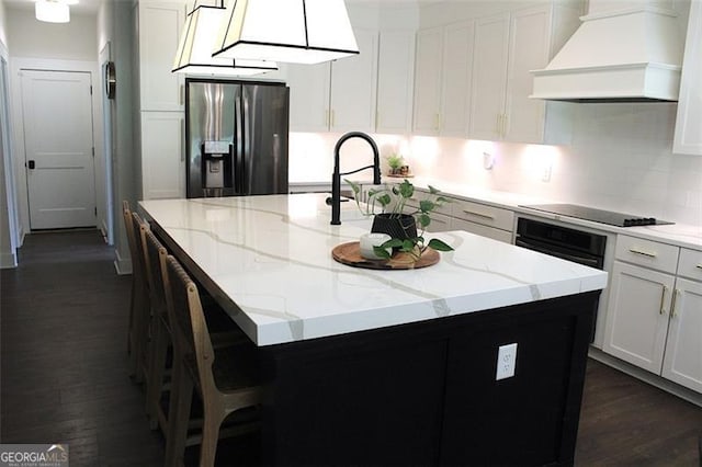 688 Harmony Rd, Temple, GA 30179 - kitchen featuring custom exhaust hood, black appliances, an island with sink, dark wood-style floors, and light stone counters