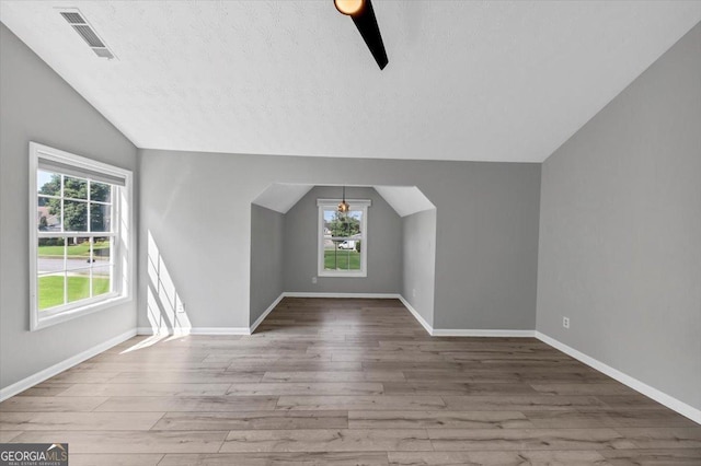5195 Oaks Landing Ct, Sugar Hill, GA 30518 - bonus room featuring vaulted ceiling, wood finished floors, a textured ceiling, and a ceiling fan