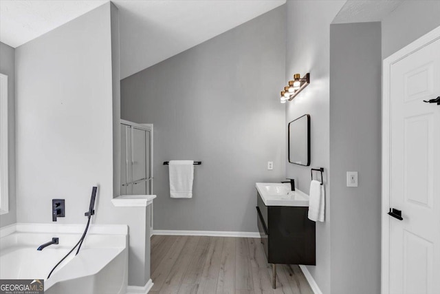 5195 Oaks Landing Ct, Sugar Hill, GA 30518 - full bath with wood finished floors, vanity, a tub, and a shower stall