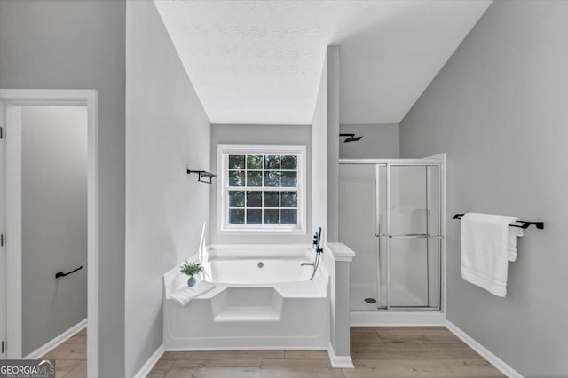 5195 Oaks Landing Ct, Sugar Hill, GA 30518 - full bath featuring a stall shower, a garden tub, and wood finished floors