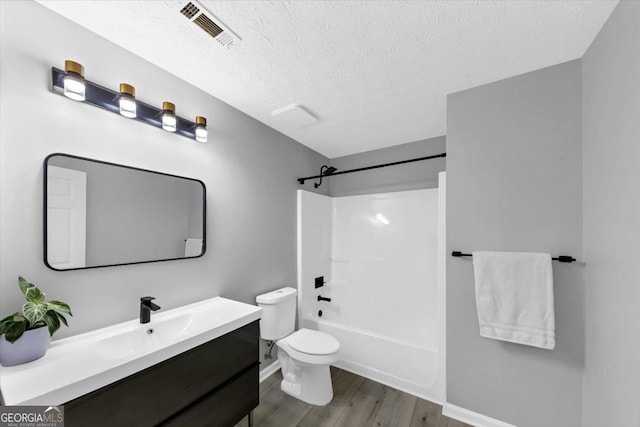 5195 Oaks Landing Ct, Sugar Hill, GA 30518 - full bathroom with vanity, wood finished floors, a textured ceiling, and bathtub / shower combination