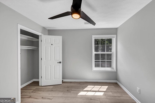 5195 Oaks Landing Ct, Sugar Hill, GA 30518 - unfurnished bedroom with wood finished floors, a closet, and a ceiling fan