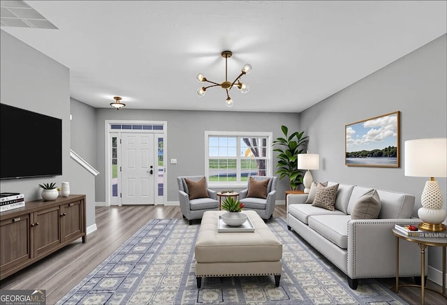 5195 Oaks Landing Ct, Sugar Hill, GA 30518 - living room with light wood-type flooring and a chandelier
