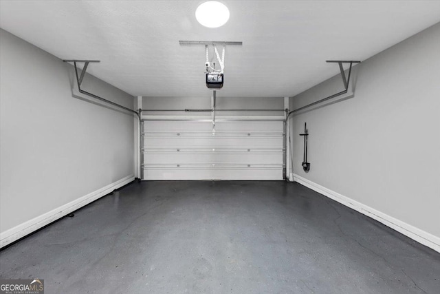 5195 Oaks Landing Ct, Sugar Hill, GA 30518 - garage with a garage door opener and baseboards