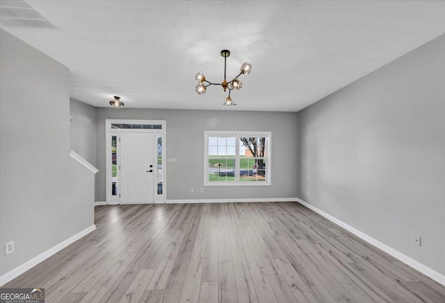 5195 Oaks Landing Ct, Sugar Hill, GA 30518 - entrance foyer with a chandelier and wood finished floors