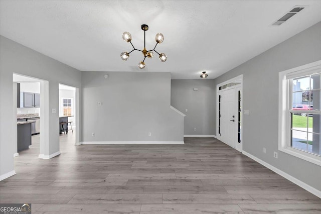 5195 Oaks Landing Ct, Sugar Hill, GA 30518 - unfurnished living room featuring a chandelier and wood finished floors