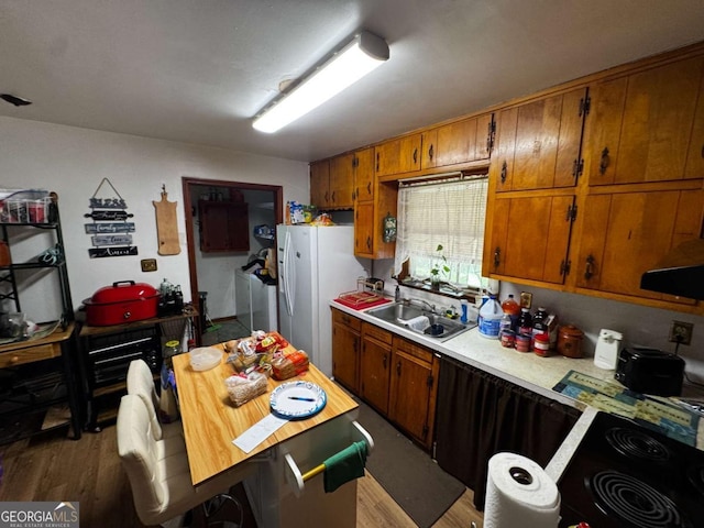 2933 Arlington Rd, East Point, GA 30344 - kitchen with wood finished floors, white fridge with ice dispenser, light countertops, and brown cabinets