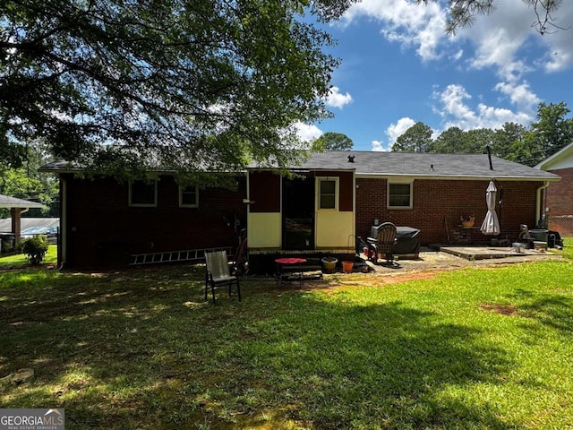 2933 Arlington Rd, East Point, GA 30344 - rear view of house with a lawn, brick siding, and a patio area