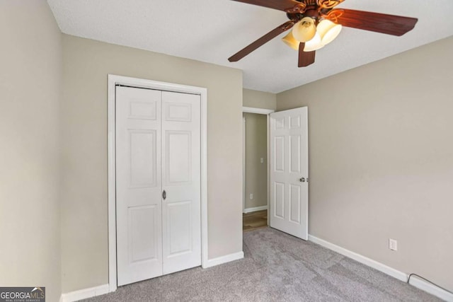 73 Azalea Dr, Villa Rica, GA 30180 - unfurnished bedroom featuring carpet, a closet, and a ceiling fan