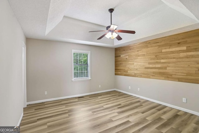 73 Azalea Dr, Villa Rica, GA 30180 - spare room with wood walls, ceiling fan, wood finished floors, and a textured ceiling
