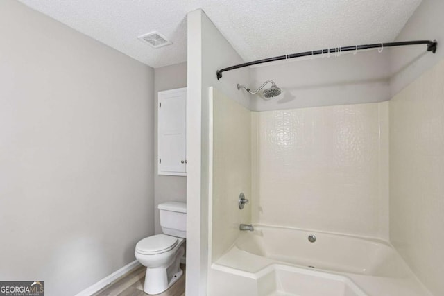 73 Azalea Dr, Villa Rica, GA 30180 - bathroom featuring  shower combination, wood finished floors, and a textured ceiling
