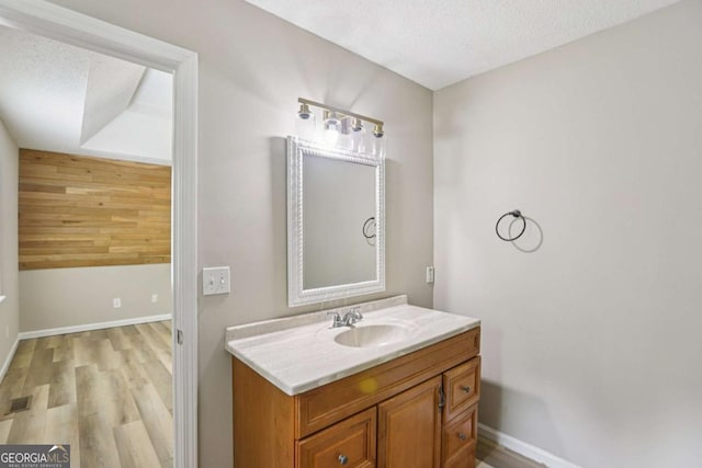 73 Azalea Dr, Villa Rica, GA 30180 - bathroom featuring wood finished floors, vanity, and a textured ceiling