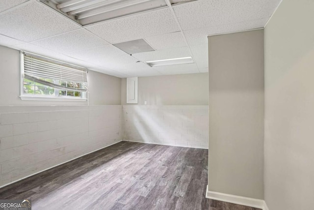 73 Azalea Dr, Villa Rica, GA 30180 - basement featuring a paneled ceiling, wood finished floors, and concrete block wall
