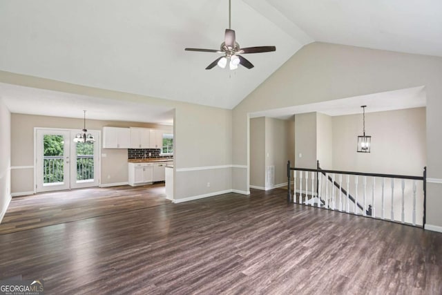 73 Azalea Dr, Villa Rica, GA 30180 - unfurnished living room featuring ceiling fan, a chandelier, dark wood finished floors, and high vaulted ceiling