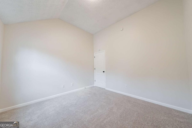 4815 Price St, Forest Park, GA 30297 - carpeted empty room with vaulted ceiling and a textured ceiling