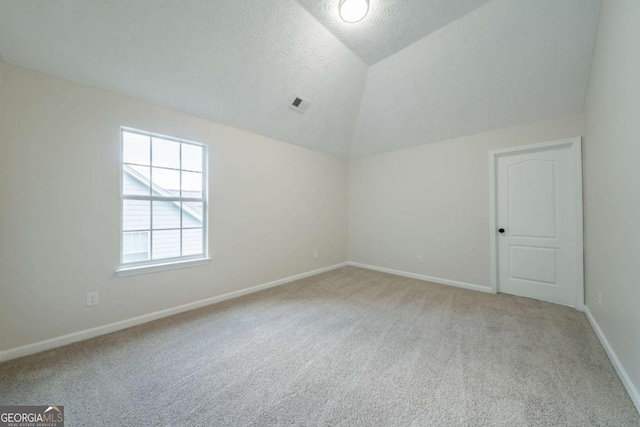 4815 Price St, Forest Park, GA 30297 - bonus room with light colored carpet, a textured ceiling, and vaulted ceiling