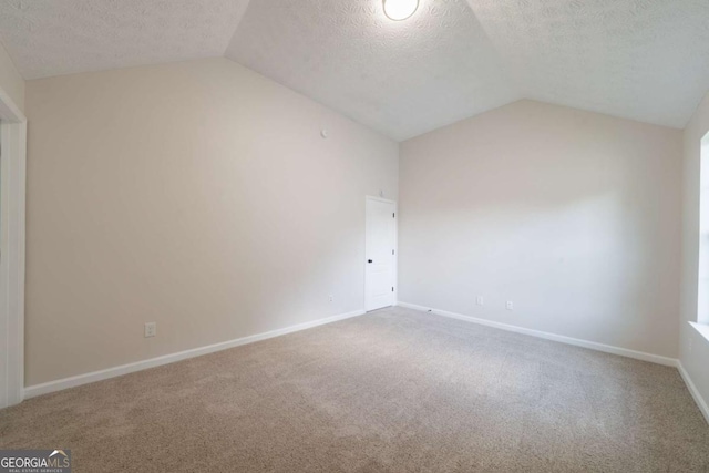 4815 Price St, Forest Park, GA 30297 - bonus room with vaulted ceiling, a textured ceiling, and carpet