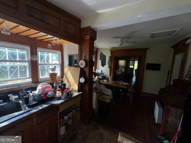 6733 Old Covington Rd, Lithonia, GA 30058 - kitchen with a ceiling fan and brown cabinetry