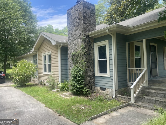 212 Rockmart Rd, Villa Rica, GA 30180 - view of side of home featuring a chimney, crawl space, and roof with shingles