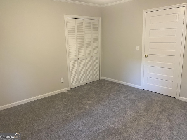 212 Rockmart Rd, Villa Rica, GA 30180 - unfurnished bedroom featuring crown molding, dark carpet, and a closet
