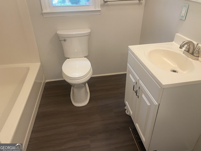 212 Rockmart Rd, Villa Rica, GA 30180 - full bath featuring wood finished floors, vanity, and a tub to relax in