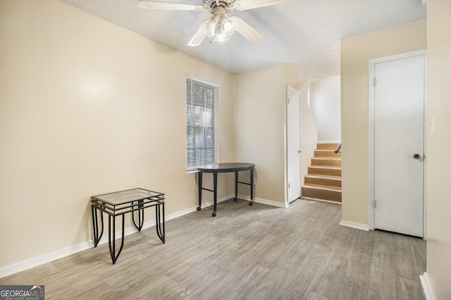 1077 Mainstreet Valley Dr, Stone Mountain, GA 30088 - empty room with wood finished floors, ceiling fan, and stairs