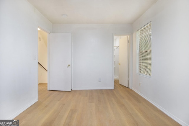 1077 Mainstreet Valley Dr, Stone Mountain, GA 30088 - unfurnished bedroom with light wood-type flooring and a spacious closet