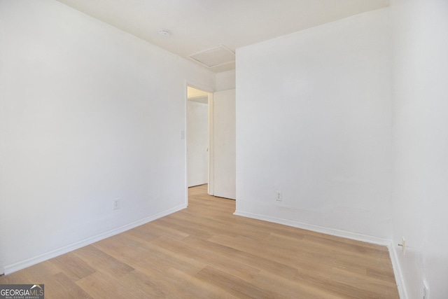 1077 Mainstreet Valley Dr, Stone Mountain, GA 30088 - unfurnished room featuring attic access and light wood-style floors