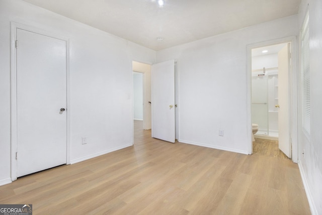 1077 Mainstreet Valley Dr, Stone Mountain, GA 30088 - unfurnished bedroom with light wood finished floors and ensuite bath