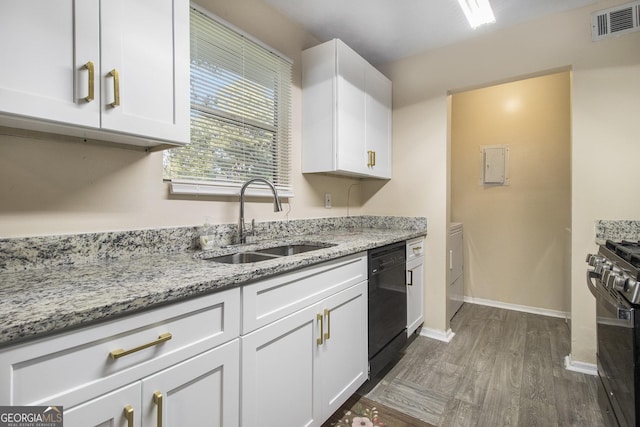 1077 Mainstreet Valley Dr, Stone Mountain, GA 30088 - kitchen featuring range, dishwasher, independent washer and dryer, white cabinets, and light stone countertops