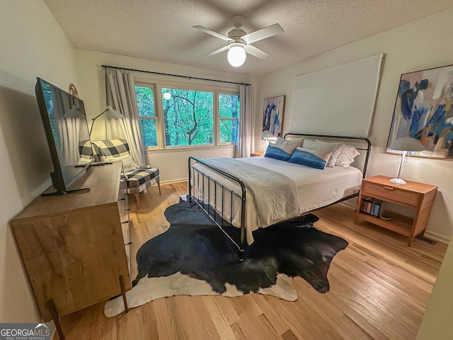 278 W Sugarbush Dr, Dillard, GA 30537 - bedroom with a textured ceiling, wood finished floors, and ceiling fan