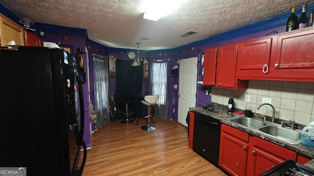 20 Bacchus Dr, Lawrenceville, GA 30045 - kitchen with freestanding refrigerator, dishwasher, light wood-style flooring, tasteful backsplash, and a textured ceiling