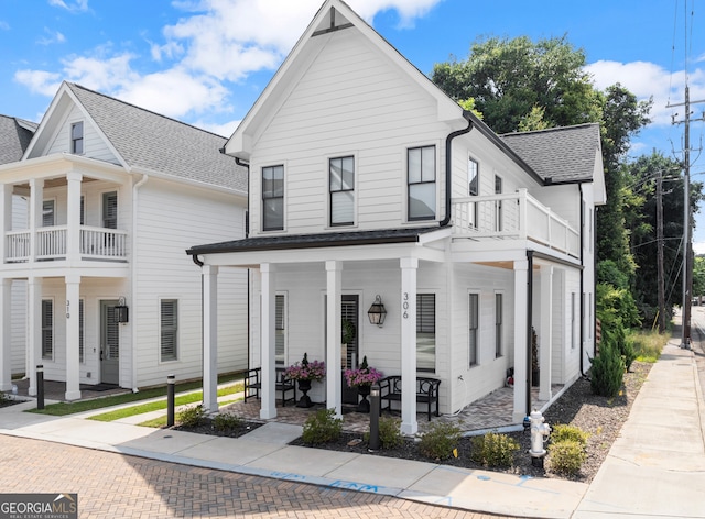 306 Clarendon Ct SE, Gainesville, GA 30501 - view of front of home with covered porch, a balcony, and a shingled roof