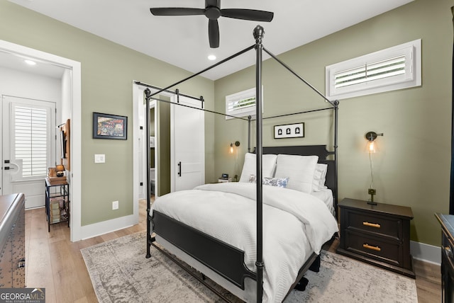 306 Clarendon Ct SE, Gainesville, GA 30501 - bedroom featuring a barn door, light wood-style floors, and recessed lighting