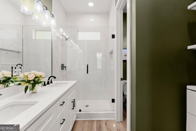 306 Clarendon Ct SE, Gainesville, GA 30501 - full bath with double vanity, a stall shower, and wood finished floors