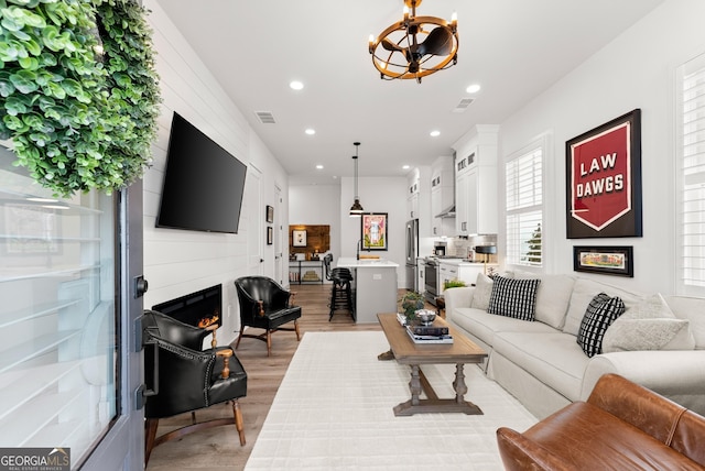 306 Clarendon Ct SE, Gainesville, GA 30501 - living area with light wood-type flooring, recessed lighting, a chandelier, and a fireplace
