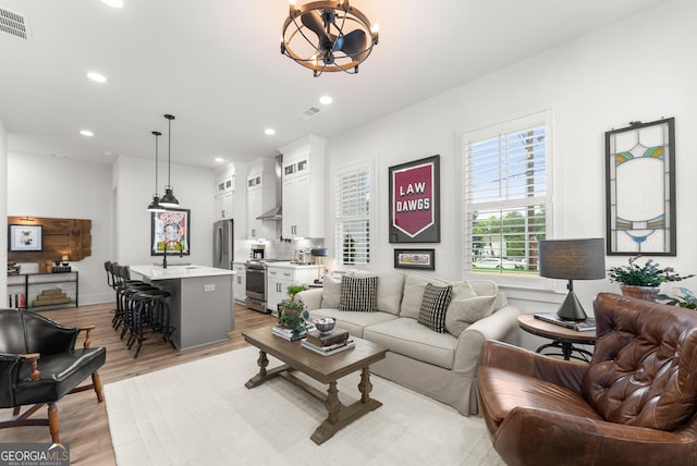 306 Clarendon Ct SE, Gainesville, GA 30501 - living room featuring light wood-style floors, recessed lighting, and a chandelier