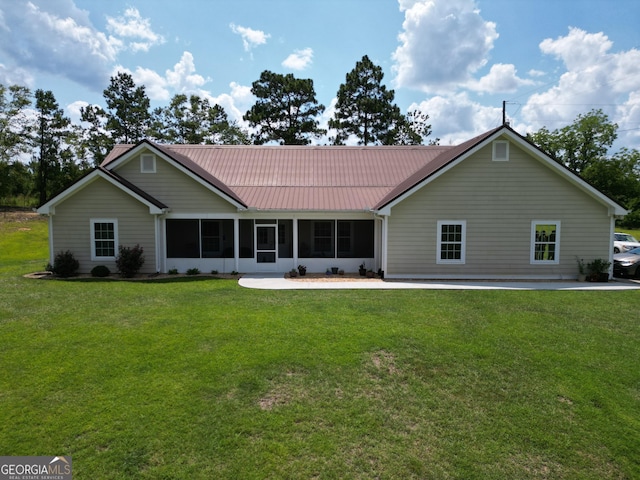 722 Gumlog Rd, Wrightsville, GA 31096 - rear view of house featuring a yard, a sunroom, and a metal roof