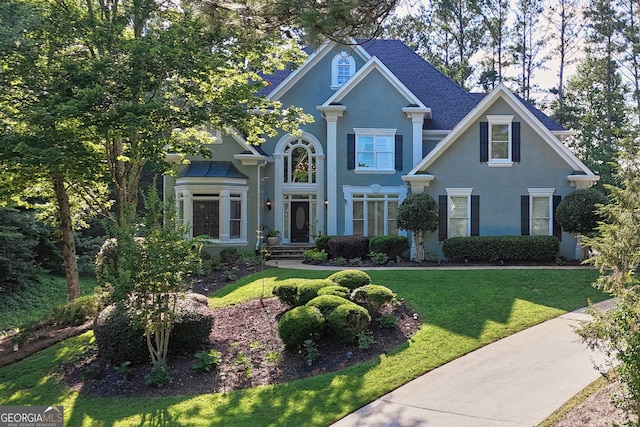 4030 Greatwood Path, Alpharetta, GA 30005 - traditional home featuring stucco siding, a front lawn, and a shingled roof