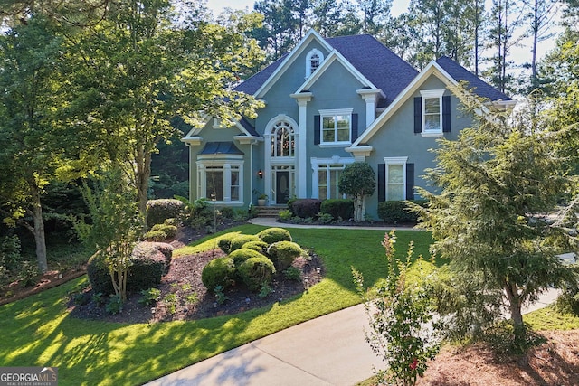 4030 Greatwood Path, Alpharetta, GA 30005 - view of front of home with a front lawn, stucco siding, and roof with shingles