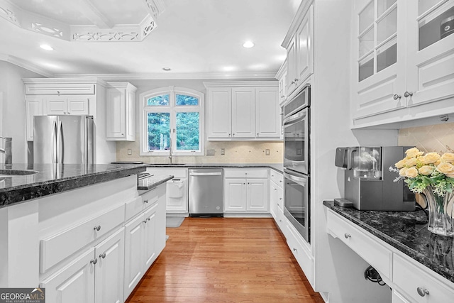 4030 Greatwood Path, Alpharetta, GA 30005 - kitchen with stainless steel appliances, ornamental molding, white cabinetry, light wood-type flooring, and dark stone counters