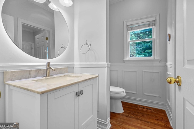 4030 Greatwood Path, Alpharetta, GA 30005 - bathroom featuring vanity, wood finished floors, a decorative wall, wainscoting, and crown molding