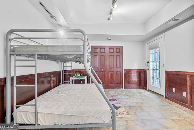 4030 Greatwood Path, Alpharetta, GA 30005 - bedroom with rail lighting, wainscoting, a raised ceiling, and stone finish floors