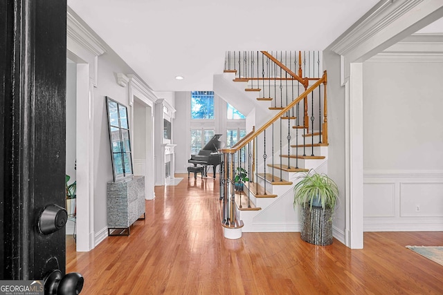 4030 Greatwood Path, Alpharetta, GA 30005 - entryway with stairs, wood finished floors, a fireplace, a wainscoted wall, and recessed lighting