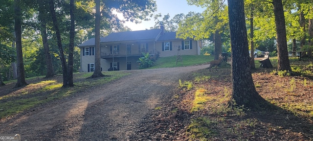 1605 Cody Rd, Mount Airy, GA 30563 - view of front facade with dirt driveway and a balcony