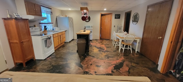 1605 Cody Rd, Mount Airy, GA 30563 - kitchen with white appliances, under cabinet range hood, a paneled ceiling, brown cabinets, and recessed lighting