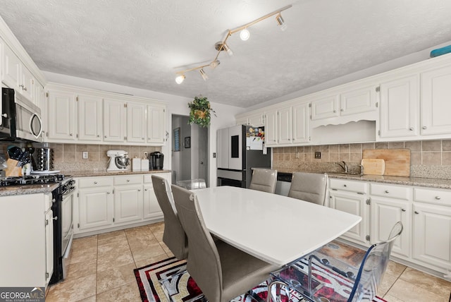 625 Hickory Nobb, Sugar Hill, GA 30518 - kitchen featuring stainless steel appliances, white cabinets, decorative backsplash, light stone counters, and a textured ceiling