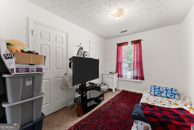 625 Hickory Nobb, Sugar Hill, GA 30518 - carpeted bedroom featuring a textured ceiling